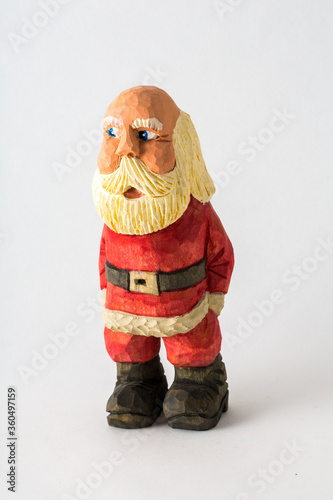 a styalized bald Santa Claus figurine on an isolated white background. photo