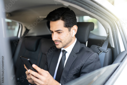 Young Businessman Using Smartphone In Car © AntonioDiaz