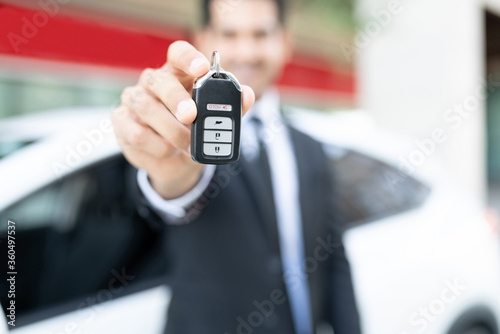 Male Dealer Showing Car Key