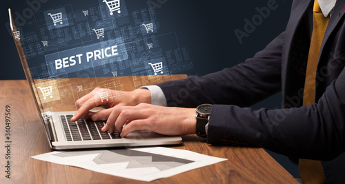 Businessman working on laptop with BEST PRICE inscription, online shopping concept