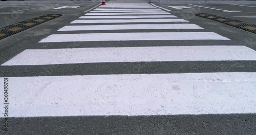 Pedestrian crossing, zebra, along the crosswalk.