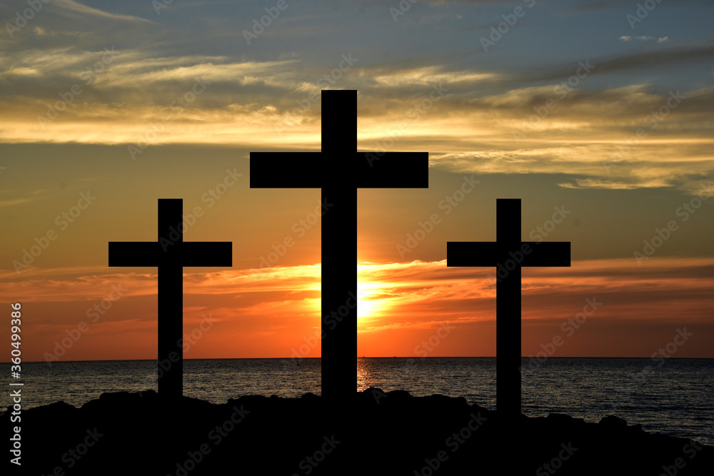 Silhouette Cross Crucifixion Of Jesus Christ on the mountain with sunset background, Easter concept.