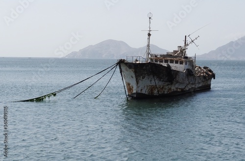 Corroded shipwreck of a motorship in the harbour of Samanco (Central coast of Peru) photo