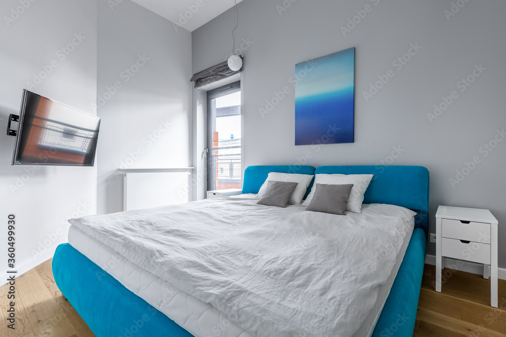 Fototapeta premium Modern bedroom with blue bed