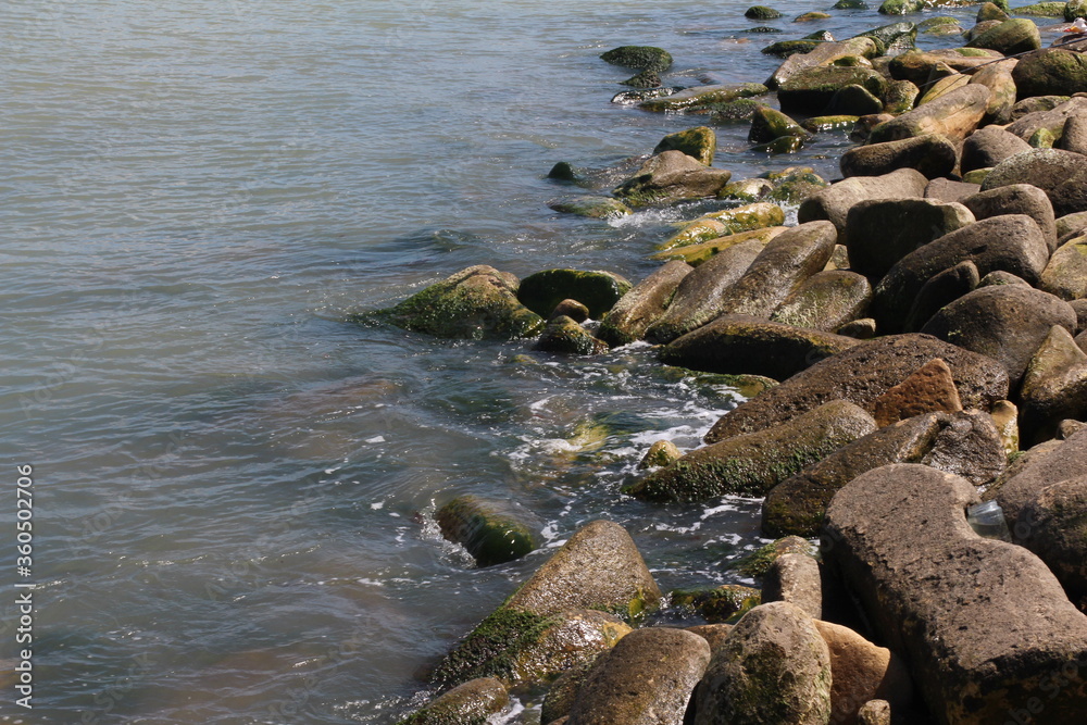 Sea pebble. Sea stones background. Ocean beach rocks.