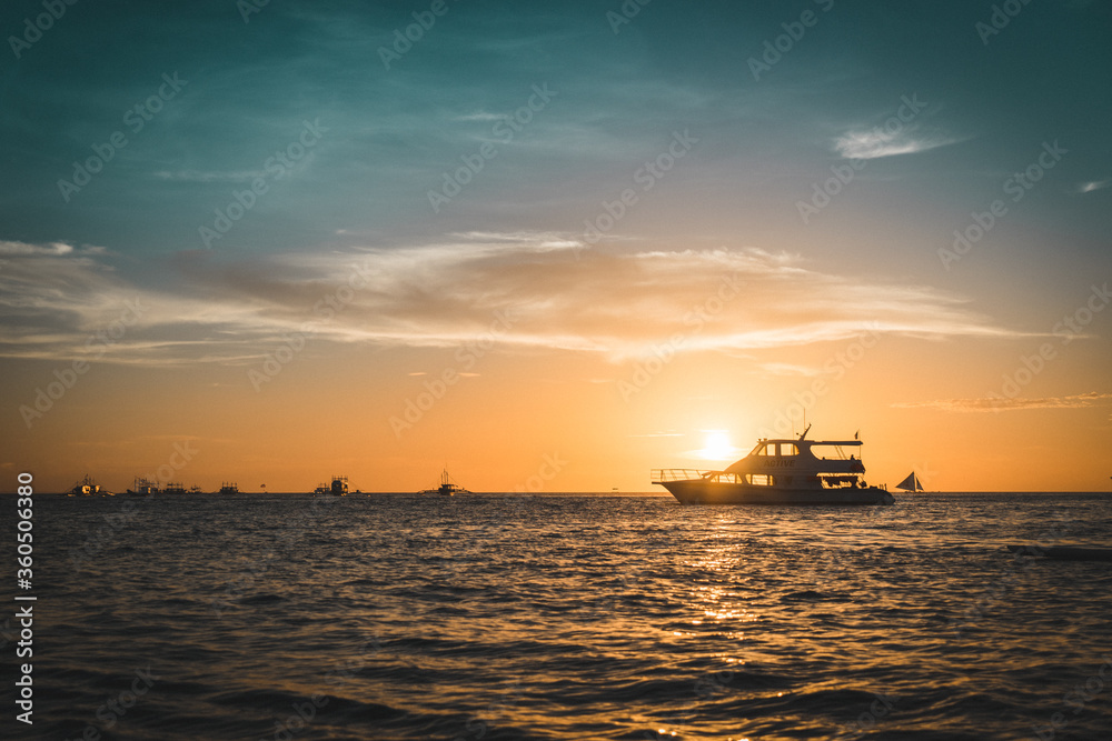 Boat with the sunset over the sea.