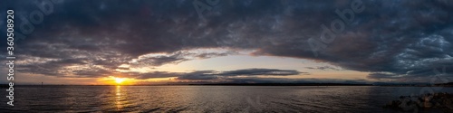 White Rock, Greater Vancouver, British Columbia, Canada. Beautiful Panoramic View of a cloudy and colorful sunset over the Pacific Ocean Coast. Nature Background Panorama © edb3_16