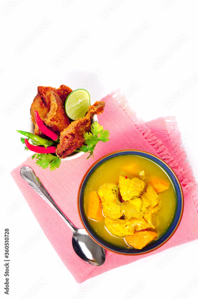 Yellow hot sour fish with yam and light mango served with fried salted fish/ Local food in southern Thailand Yellow hot sour fish with yam and light mango served with fried salted fish/ Local food in southern Thailand