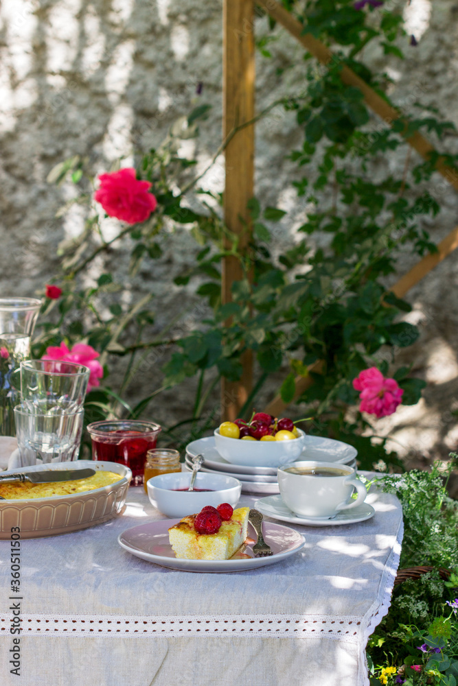 Breakfast in the garden from casseroles, berries, sauces and drinks. Rustic style. Breakfast in the garden from casseroles, berries, sauces and drinks. Rustic style.