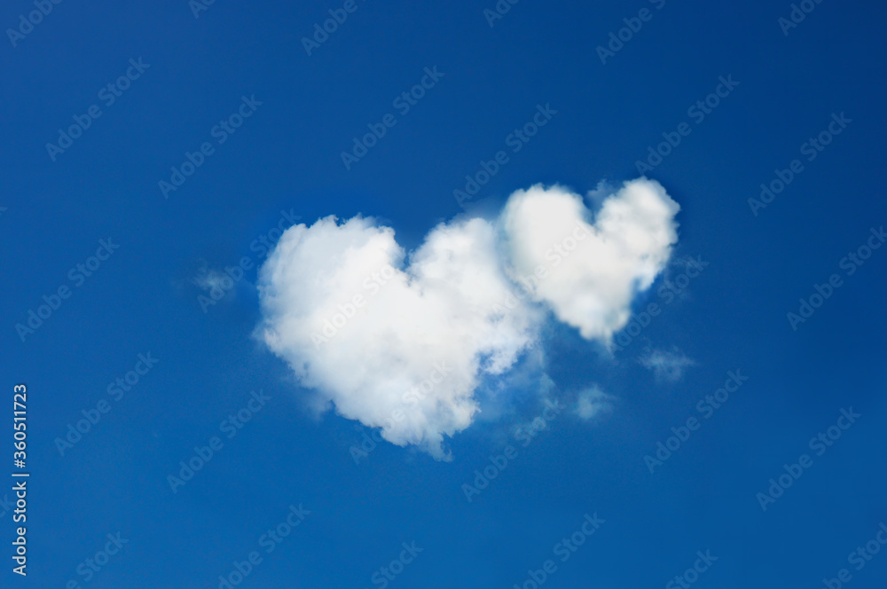twin clouds shaped heart on bright blue sky