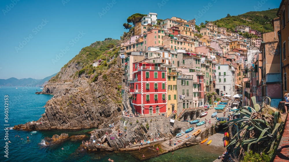 Italian landmark village Riomaggiore, view of the colorful houses along the coastline of Cinque Terre area in Italy.