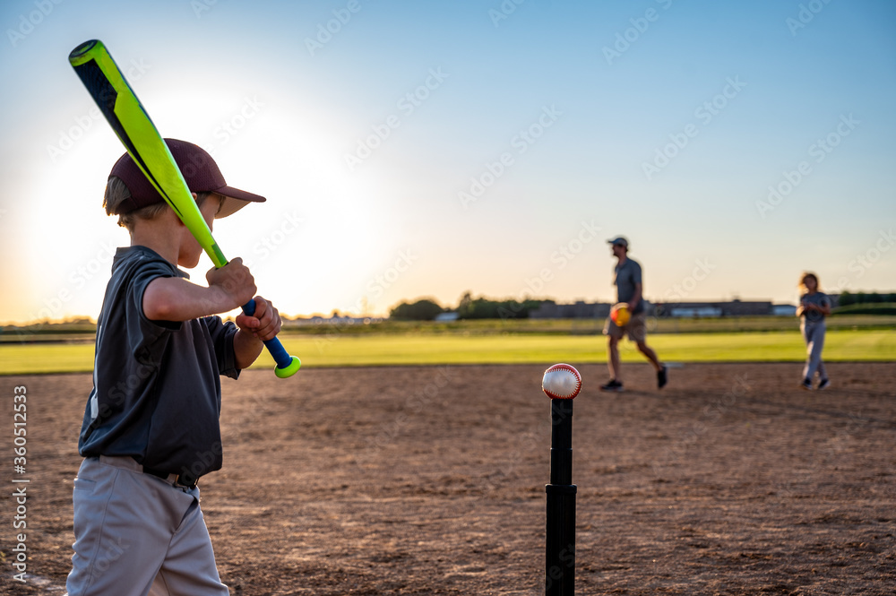Caucasian boy with baseball bat at home plate ready to hit a ball off a