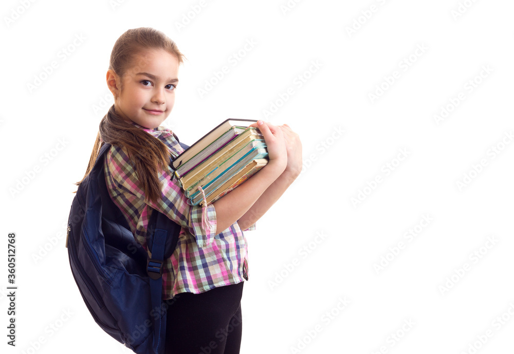 Schoolgirl holding bunch of books in her hands Schoolgirl holding bunch of books in her hands