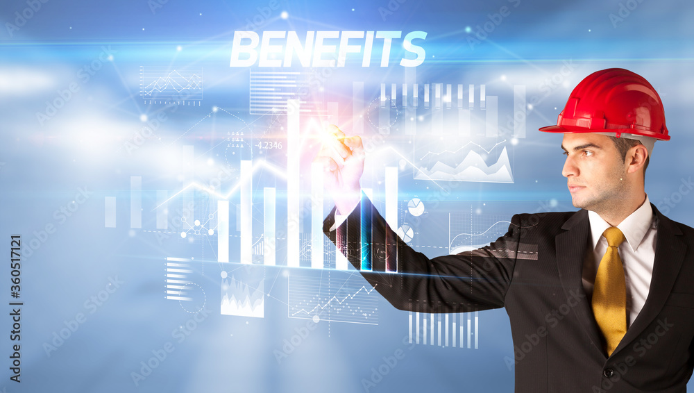 Handsome businessman with helmet drawing BENEFITS inscription, architecture business plan concept
