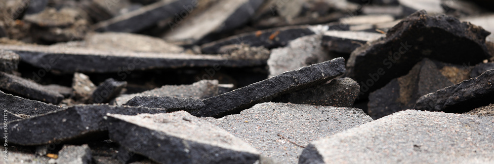 Damaged road with pieces of broken asphalt part Damaged road with pieces of broken asphalt part