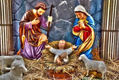 Fotografie, Obraz Statuettes of Mary, Joseph and baby Jesus,The birthday of Jesus is a statuette of Maria with Joseph and newborn Jesus on the hay, A Christmas nativity scene