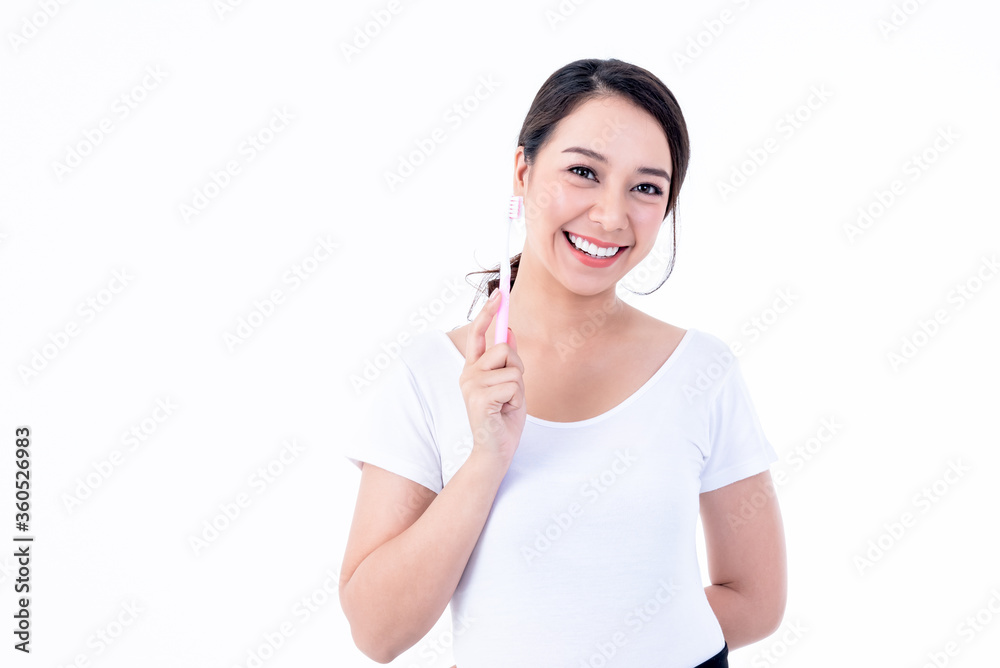 Portrait images of Asian young, pretty woman is 25 years old, She has beautiful white and clean teeth and holding a toothbrush, On white background to people and dental health concept. Portrait images of Asian young, pretty woman is 25 years old, She has beautiful white and clean teeth and holding a toothbrush, On white background to people and dental health concept.