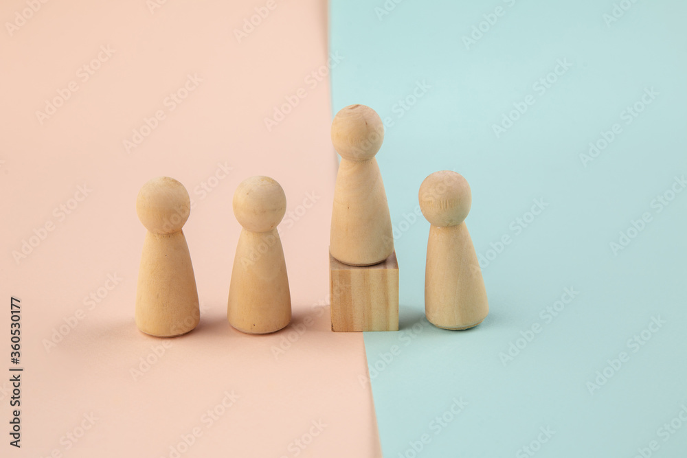 Wooden figure standing on the box for show influence and empowerment. Concept of business leadership for leader team. Wooden figure standing on the box for show influence and empowerment. Concept of business leadership for leader team.