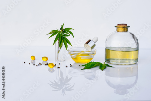 Pharmaceutical CBD oil and cannabis tincture on a white laboratory desk. The concept of medical marijuana and alternative medicine