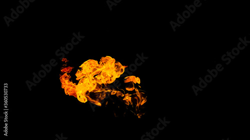 Fire flames on black background isolated. Burning gas or gasoline burns with fire and flames. Flaming burning sparks close-up  fire patterns. Infernal glow of fire in the dark with copy-space