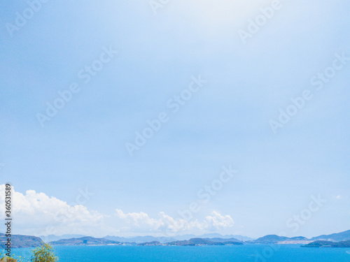 Deep blue ocean panorama with boat in a turquoise tropical sea under clear sky background. Tropical holiday paradise concept  the end of quarantine Covid 19 isolation - beginning of normal life again