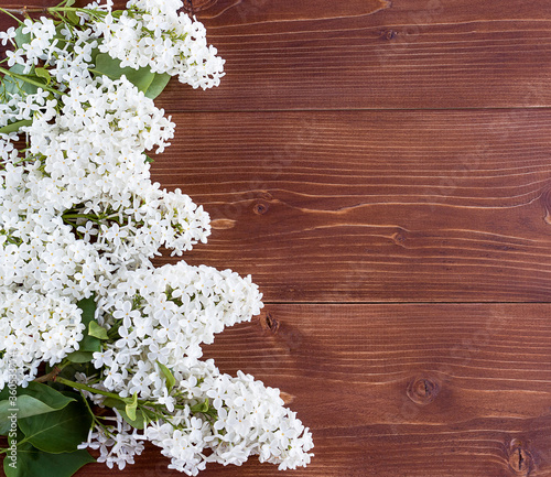 Blooming white lilac on a wooden background. Flatley. copyspase