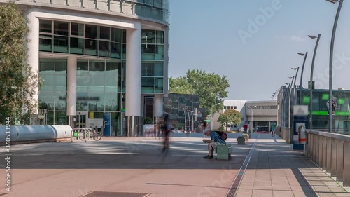 Donaustadt Danube City timelapse is a modern quarter with skyscrapers and business centres in Vienna, Austria. Modern architecture with people walking on walkways photo