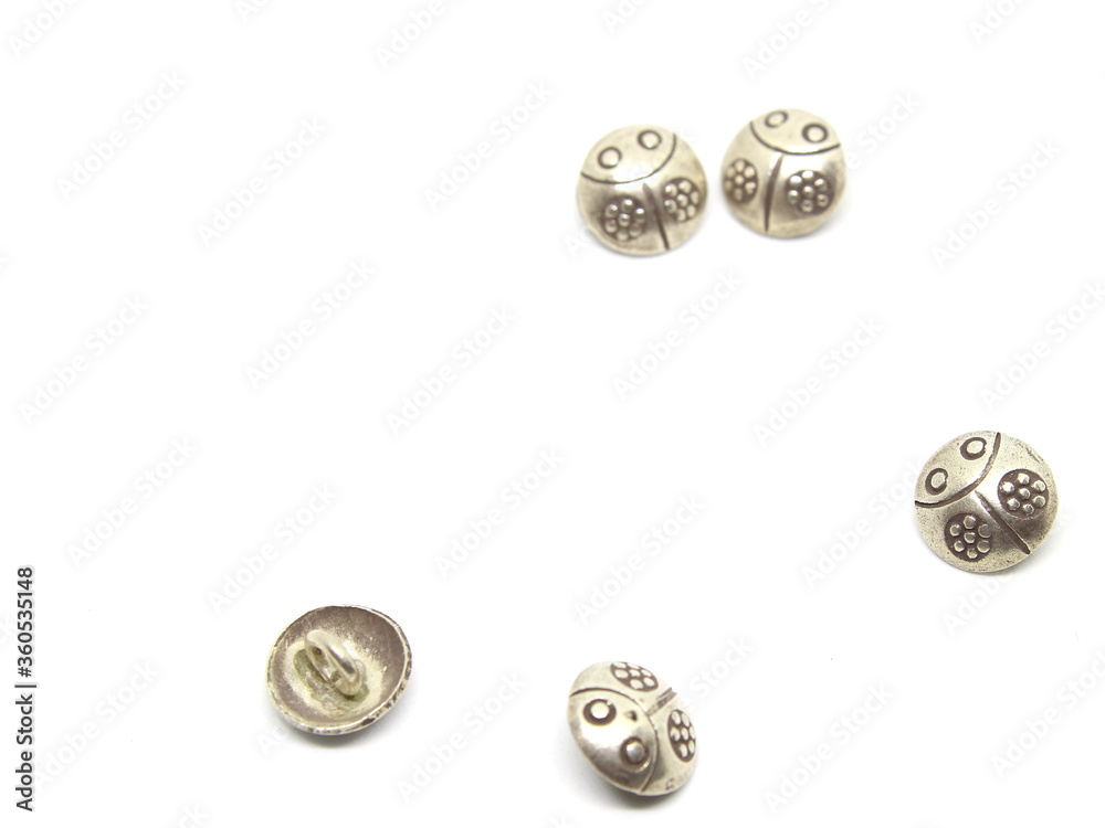 Silver ladybug buttons on white background. Silver ladybug buttons on white background.