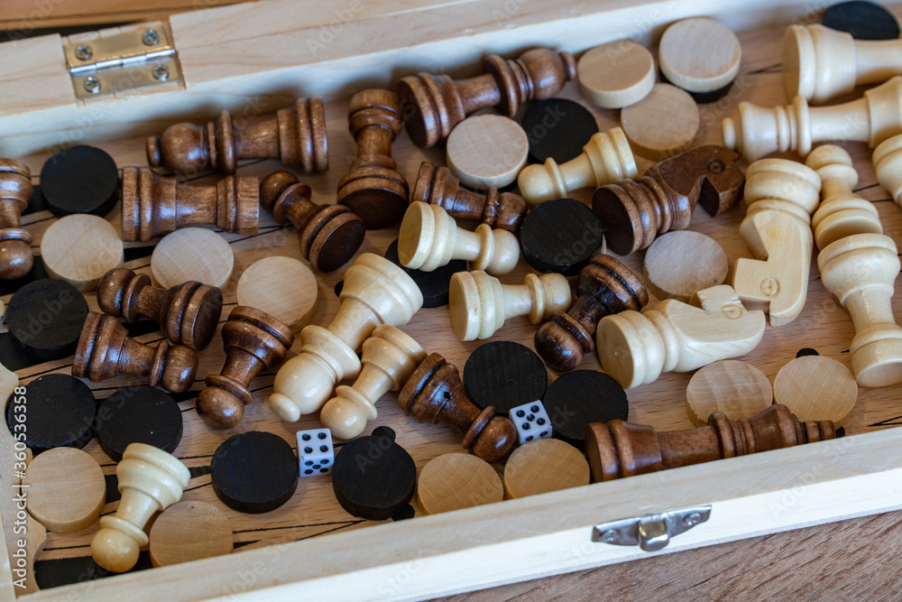 Checkers and chess are randomly mixed scattered in a box