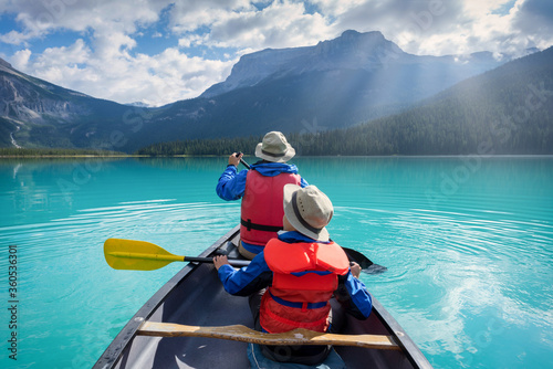 father and son canoeing in Emerald lake in the Canadian rockies © romylee