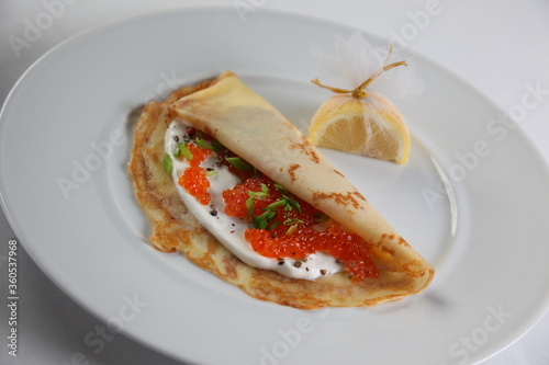 Blinis with red caviar photo