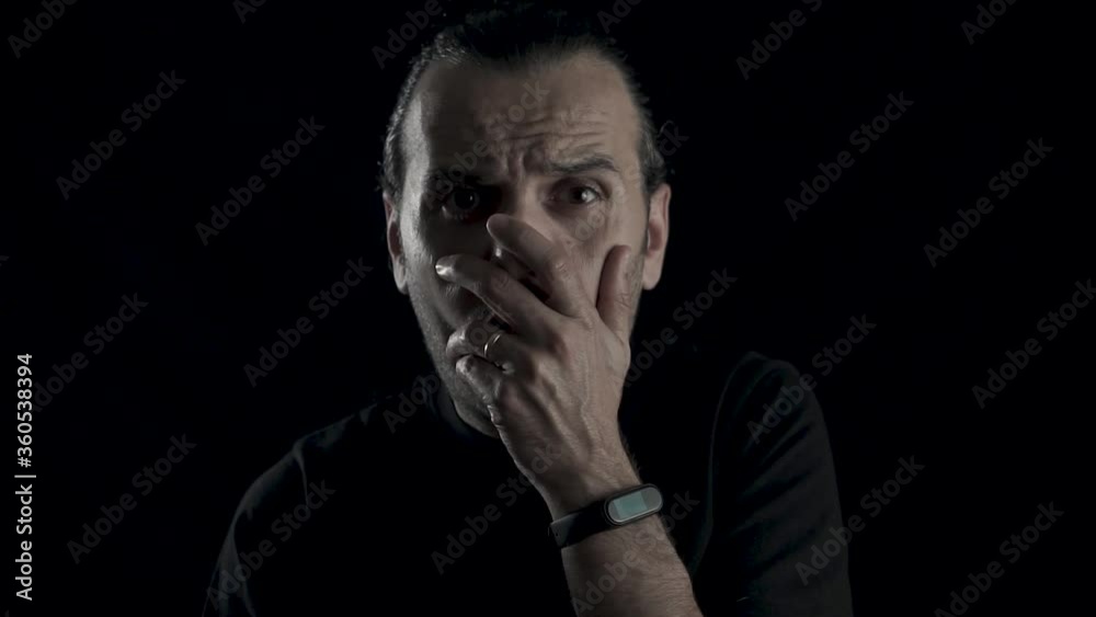 Young handsome guy is unhappy and shocked. Surprised male on black background, studio face shot. Young handsome guy is unhappy and shocked. Surprised male on black background, studio face shot.
