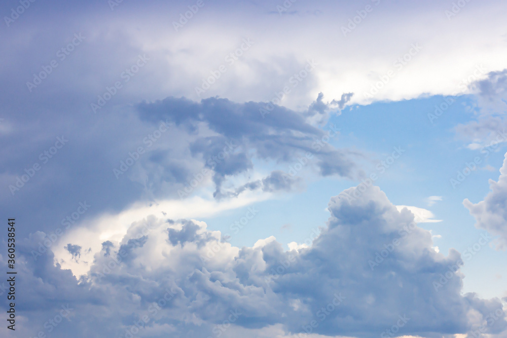 Simple beautiful gloomy blue sky with fluffy clouds in summer morning peace day as a background. Gray, white and turquoise color blurred skyline texture photography. Simple beautiful gloomy blue sky with fluffy clouds in summer morning peace day as a background. Gray, white and turquoise color blurred skyline texture photography.