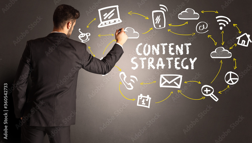 businessman drawing social media icons with CONTENT STRATEGY inscription, new media concept businessman drawing social media icons with CONTENT STRATEGY inscription, new media concept