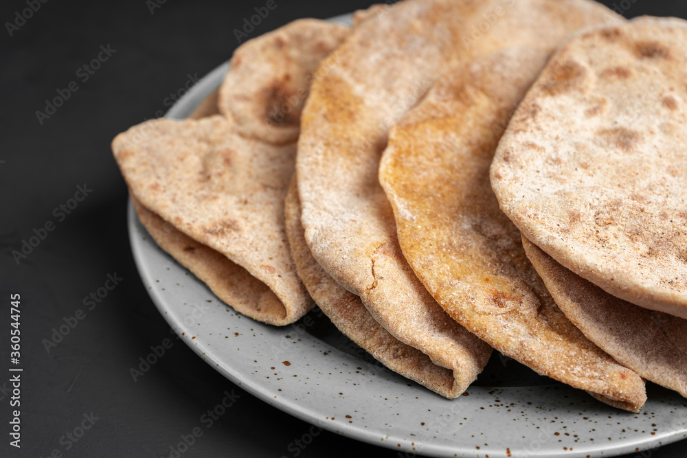 Flour tortillas with bran on a gray plate close-up