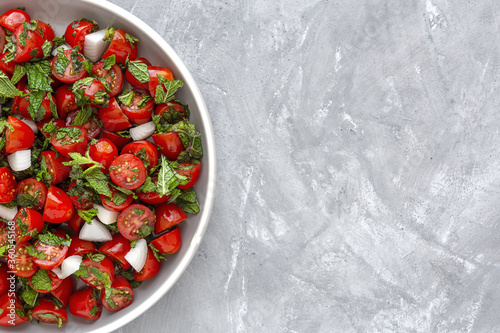 Homemade cherry tomato salad with fresh onions, mint, olive oil and salt