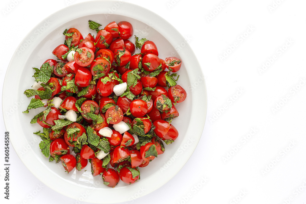 Homemade cherry tomato salad with fresh onions, mint, olive oil and salt Homemade cherry tomato salad with fresh onions, mint, olive oil and salt