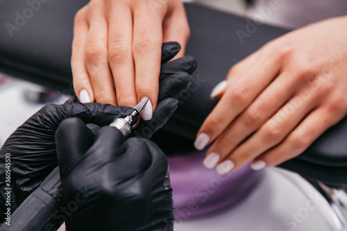 manicurist makes nails to a client  macro shot