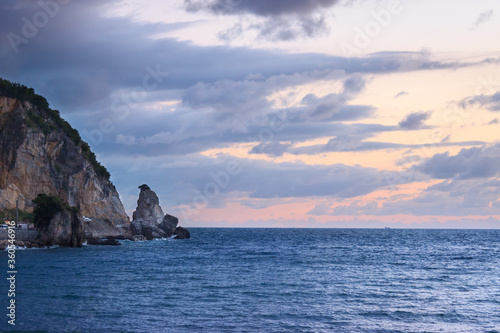 Cove and rocky mountain near the sea landscape on sunset with purple clouds. Amasra  Turkey.