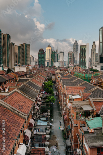 Photography New high-class Shanghai skyscrapers transform, surround and slowly take over the low old fashioned labyrinth longtangs, Hutongs alleyway neighborhood skyline