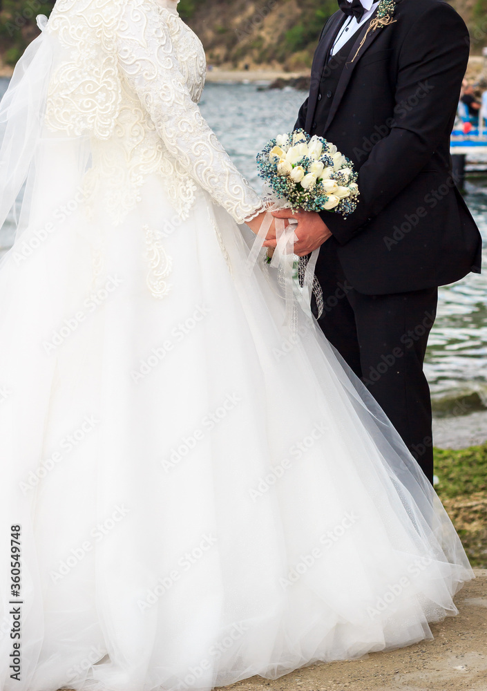 Muslim bride and groom at the harbor near the sea during a wedding ceremony. Muslim bride and groom at the harbor near the sea during a wedding ceremony.