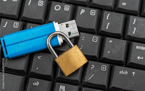 Vászonkép Flash drive with padlock on the laptop keyboard.