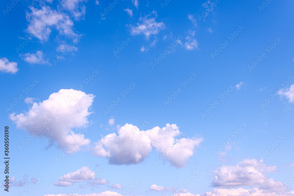 White and purple fluffy clouds on blue sky at evening