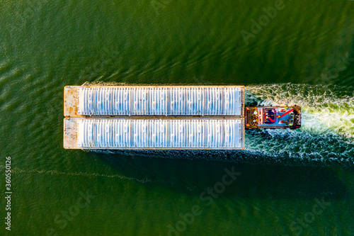 Photo Overhead view of a shipping barge moving through the intercoastal waterway