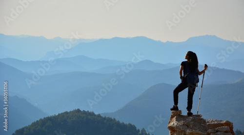 Silhouette of a woman on the top of mountain
