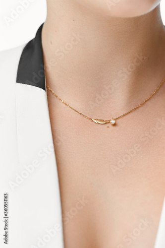 Woman's decollete with a luxury jewelry. Unusual and elegant pendant.