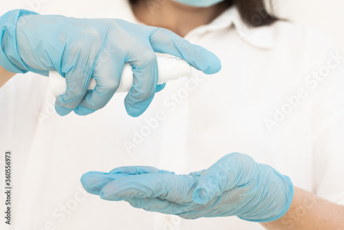  the doctor squeezes the gel from the tube onto the hand on which the glove is worn. High quality photo