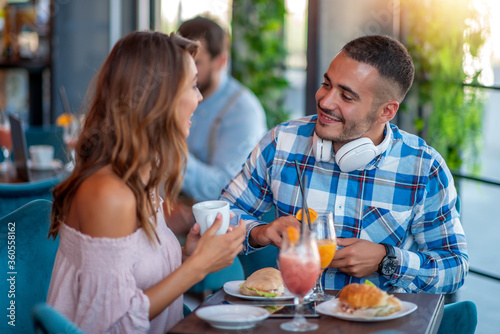 Young couple eating sandwiches