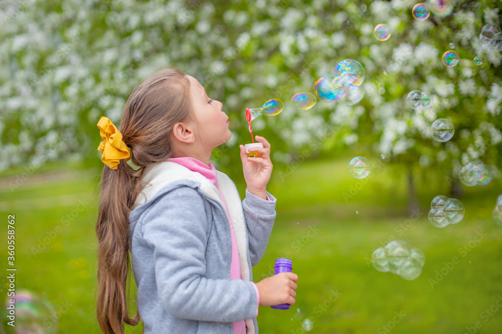 Beautiful little blonde girl, has happy fun cheerful smiling face, soap bubble blower. Beautiful little blonde girl, has happy fun cheerful smiling face, soap bubble blower.