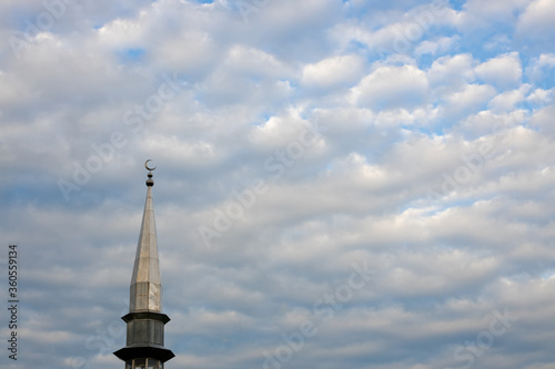 .Silhouette of minaret against the backdrop of the setting sun. Beautiful sky.